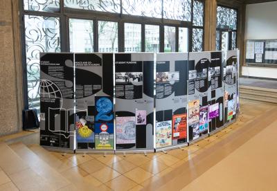 Exhibition installation featuring a half circle of typographic banners presenting a historical research about student unions in western and eastern europe.