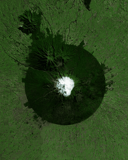 “Mount Taranaki, also known as Mount Egmont, is an active stratovolcano on the west coast of New Zealand’s North Island. A change in vegetation is sharply delineated between the protected national forest that encircles the volcano and the surrounding land comprised of intensively-farmed dairy pastures.”
