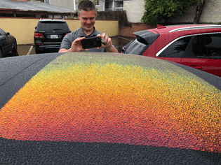 Photo of fantastic visual effect from water on car roof (and of Chris Long taking a photo of the same) by David Theriault