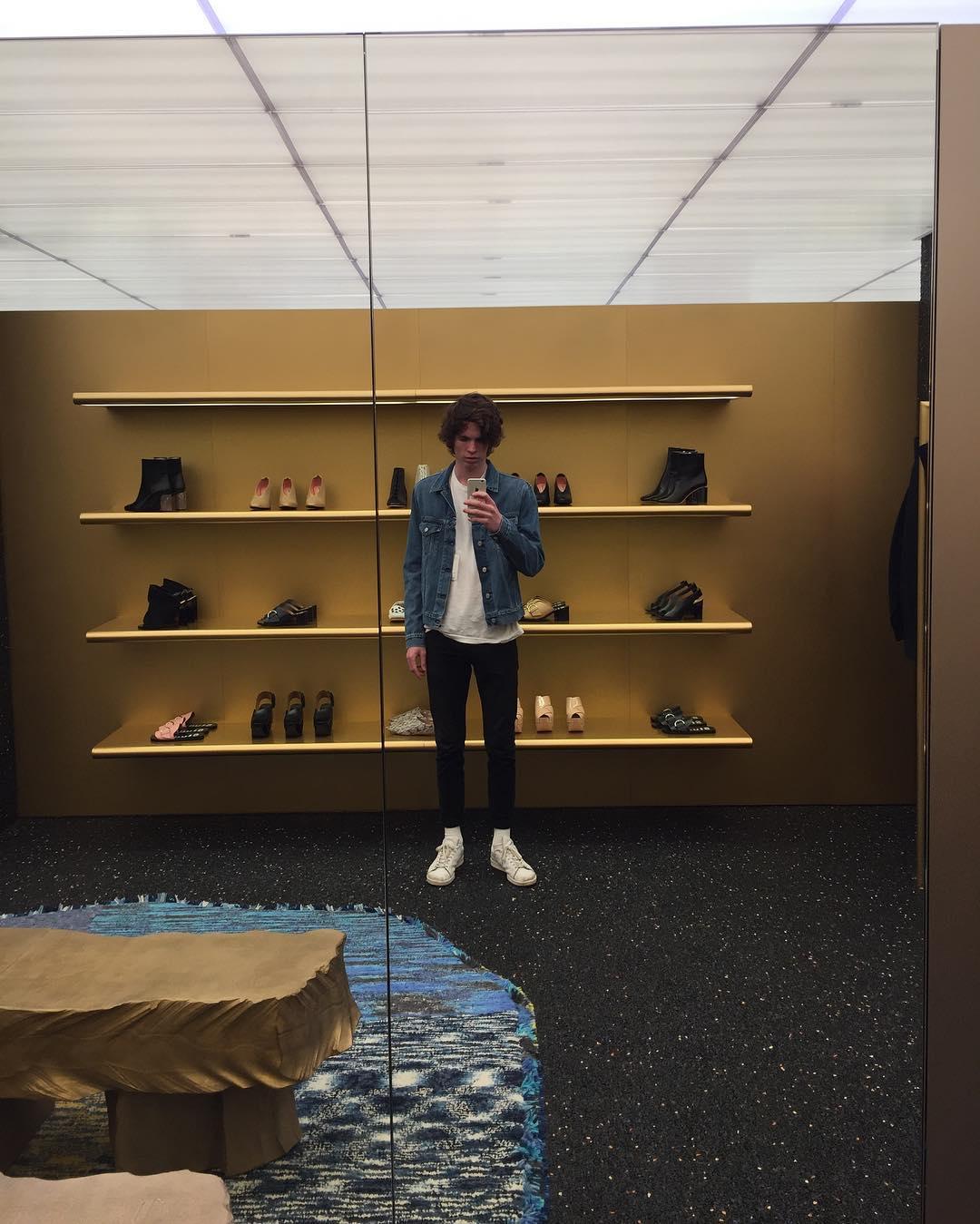 me, trying on a denim jacket at Acne Studios, in New York City