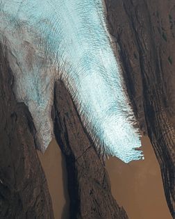 “A finger of the Cook Ice Cap meets a fjord on La Grande Terre, the largest of the Kerguelen Islands. Also known as the Desolation Islands, the Kerguelens are located in the Antarctic and are among the most isolated places on Earth — more than 2,100 miles (3,300 km) from Madagascar in the southern Indian Ocean. The islands have no indigenous inhabitants, but since they are part of the French Southern and Antarctic Lands, they host a permanent presence of 45-100 soldiers, scientists, engineers and researchers from France.”