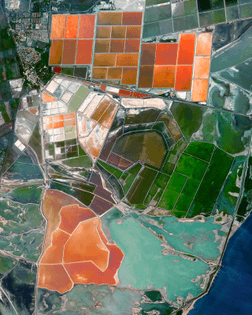 “Vibrantly colored salt evaporation ponds are seen adjacent to Port-Saint-Louis-du-Rhône in southern France. This region — known as the Camargue — lies between the Mediterranean Sea and the two arms of the Rhône River delta, forming a natural series of brine lagoons. Salt has been produced in this region for thousands of years and is sought-after worldwide for its superior quality.”
