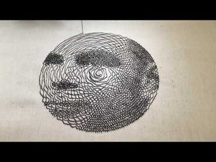 Embroidered portrait of Alan Turing with a single thread