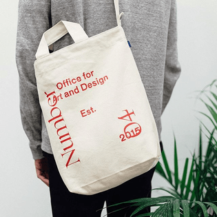 Baggu duck bag (natural) with red N04 screen print available in store and online at actualsource.org