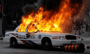 12595-a-police-car-set-on-fire-by.jpg