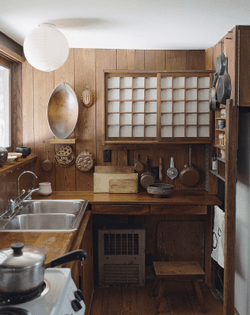 in-one-house-a-small-kitchen-features-a-cupboard-with-sliding-shoji-screens.jpg