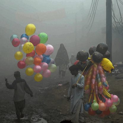 james chester on Instagram: “Pakistani balloon vendors cross a street in heavy fog in Lahore by Arif Ali, December 2016”
