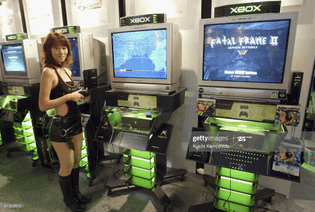 model-demonstrates-the-games-on-display-at-the-xbox-booth-during-the-picture-id51352979?s=2048x2048