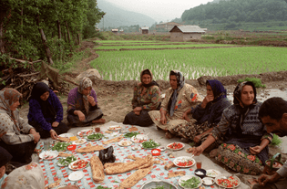 Iranian women share lunch after planting rice. 