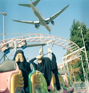 Sabiha Çimen - A plane flies low over students riding a train at a funfair over the weekend, in Istanbul, Turkey (August 29, 2018)