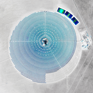“The Crescent Dunes Solar Energy Project near Tonopah, Nevada, uses 17,500 heliostat mirrors that collect and focus the sun’s thermal energy to heat molten salt flowing through a 540-foot (160 m) tall solar power tower. Seen here during its construction in 2015, the molten salt at its center then circulates from the tower to a storage tank, where it is used to produce steam and generate electricity.In a recent report, the International Energy Agency (IEA) just declared solar to be the cheapest form of electricity worldwide, saying the cost per megawatt to build a solar plant is now cheaper than any fossil fuel facility.”