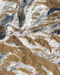 “This Overview shows a small section of the “Panlong Ancient Road” in southwestern Xinjiang, China. Located near the Chinese border with Tajikistan, this route snakes for 47 miles (75 km) through the Pamir Mountains, rising 13,450 feet (4,100 meters) above sea level. Some reports claim it has more than 600 hairpin turns.”