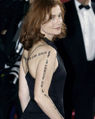 Isabelle Huppert at The Piano Teacher premiere with ‘God can thank Bach because Bach is proof of the existence of God’ sharpied on her