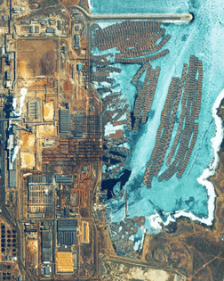 “Timber is frozen in the Angara River by a pulp mill in Bratsk, Russia. A pulp mill is a manufacturing facility that converts felled trees and wood chips into thick fiber board that is shipped to a paper mill for further processing. The facility in Bratsk handles about 540,000 cubic yards (413,000 cubic meters) of wood per year.”