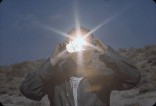 Survival training includes learning to use mirrors to signal aircraft. Reno, Nevada, January 1965. Photograph by NASA