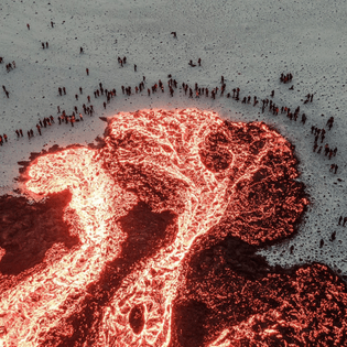 People gathered around lava, Iceland.