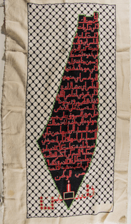 “an embroidered map of Palestine with the words of Mahmoud Darwish’s poem “I come from there””