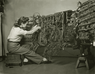 woman wiring an early IBM computer