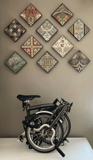 Salvaged ceramic floor tiles with Brompton bicycle