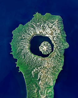 “The Tao-Rusyr Caldera is a stratovolcano located on Onekotan Island, in Russia’s Far East. Roughly 7.5 kilometers (4.6 miles) wide, it contains the waters of Kol’tsevoe Lake and a large symmetrical cone, Krenitsyn Peak, which rises from the lake. Onekotan is part of the Kuril Islands, a volcanic archipelago and segment of the “Ring of Fire” — a path of tectonic activity that circles the Pacific Ocean.”