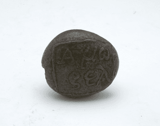 pebble with inscription in relief