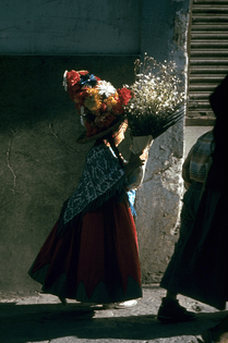 A child carrying bouquet on way to fiesta in Guanajuato, 1968. Photograph by John Dominis.