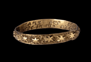 gold ring with the inscription “many are the stars i see yet in my eye no star like thee”