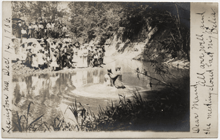 Unidentified Photographer [River baptism, Lexington, Missouri], 1906. Gelatin silver print postcard. International Center of Photography