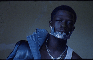 UK Rapper Pa Salieu wearing aluminum jawbone piece by Shaun Leane from the Alexander McQueen’s Spring/Summer 1998 show, for the cover story of Dazed Fall/Winter 2020, by Gabriel Moses.