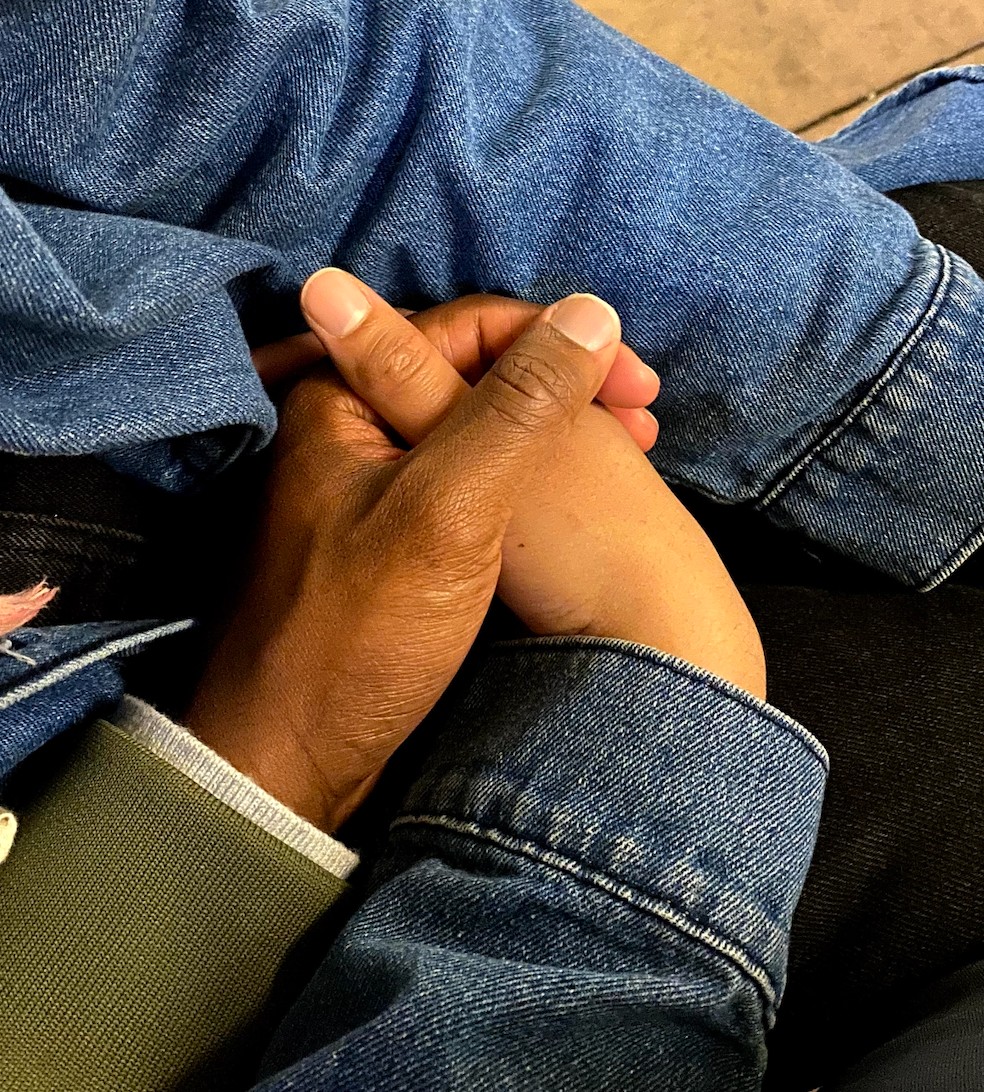 a close up of two hands holding each other.