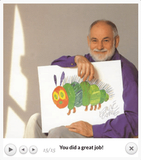 A person sitting in a sunny room with a gray-white beard in a long-sleeved purple shirt and light tan/beige pants, holding a drawing they did of a caterpillar. The person is smiling. Below the picture is text that reads, “You did a great job!”