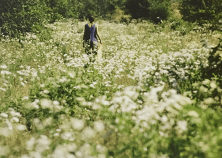Ana Mendieta in a field of flowers, Old Man’s Creek, Iowa, 1977