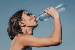 thirsty-fitness-girl-drink-water-from-bottle.jpeg.webp