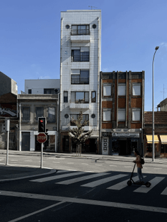 A narrow, tall high-rise building in Porto, Portugal.