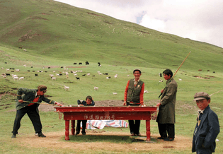 A group of Tibetan herders play billiards on the pasture， near Xiangpi Mountain, China's western Qinghai province，1999