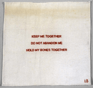 a square of plain white cloth, embroidered with small red all-caps words that read "keep me together / do not abandon me / hold my bones together"