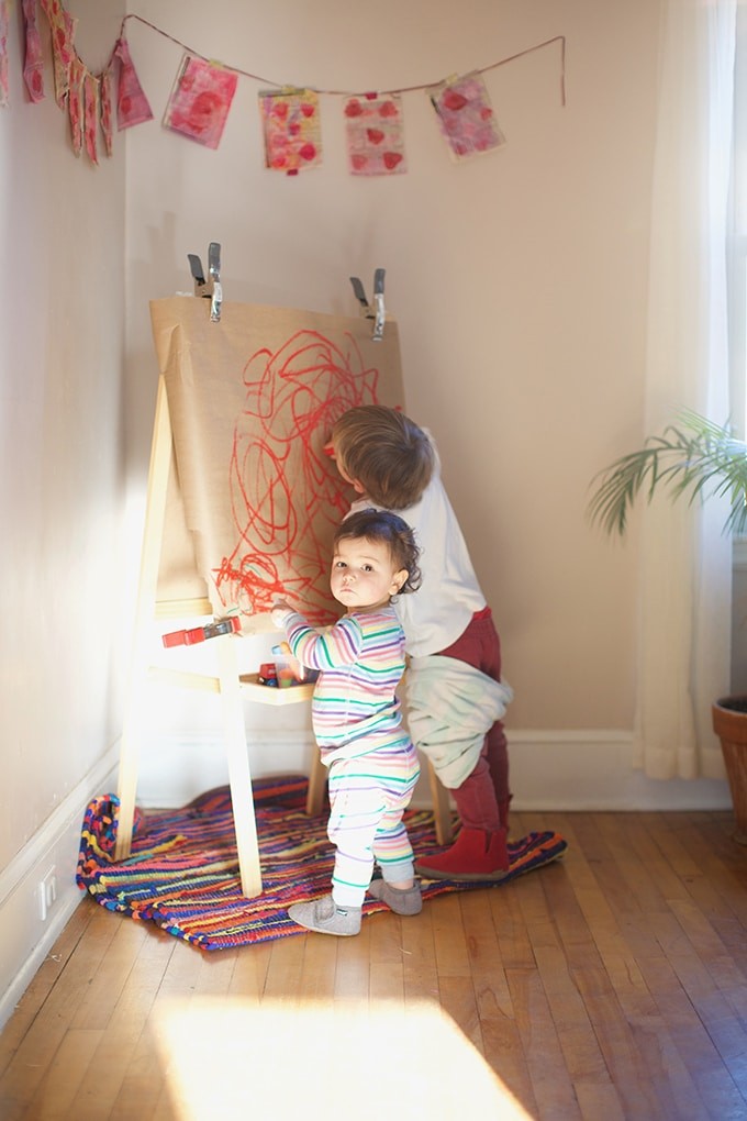 children-painting-at-easel-with-paint-sticks.jpg