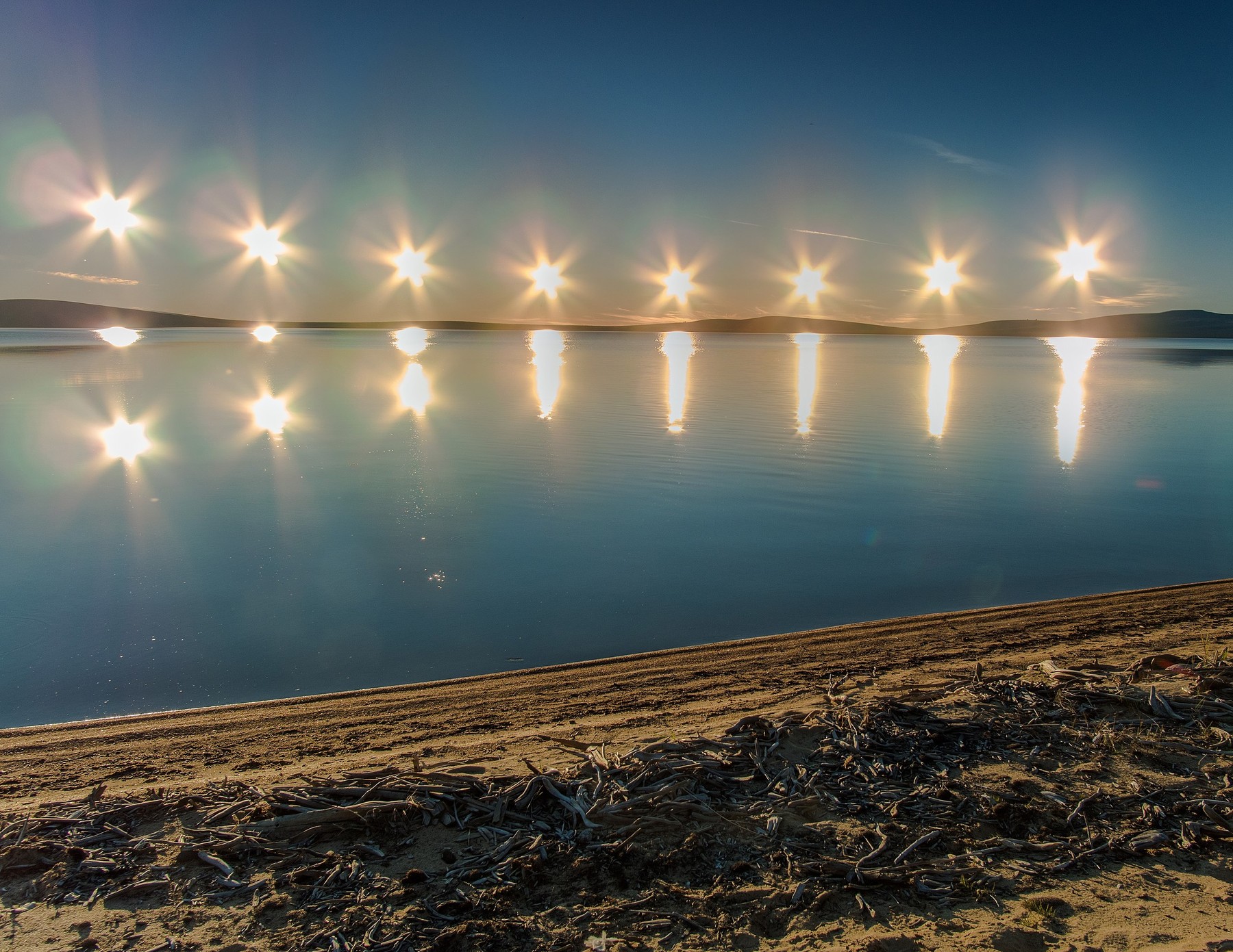 
Multiple exposure of the midnight sun on Lake Ozhogino in Yakutia, Russia