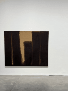Abstract painting by Yun Hyong-keun, showing dark brown hues on a sand-colored linen background.