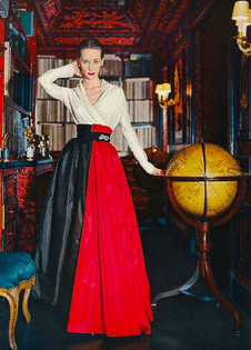 Model in a soft shirt of silk organdie with a splash of red panels over a black taffeta skirt