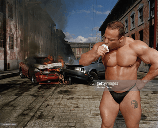 bodybuilder-eating-ice-cream-cone-car-collision-in-background-picture-id200486600-008