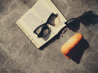 towards no obligations book, ball, sunglasses food made of local produce direct sunlight motion blur