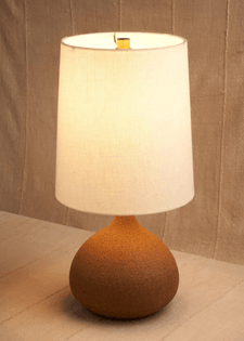 A table lamp, the base of which resembles the shape of a fig.