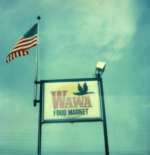 Wawa Food Market freestanding sign with American flag