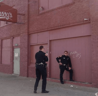 91f52de32301d46cb1bc5ca484dcf875-cops-posing-next-to-fuck-cops-graffiti.jpg