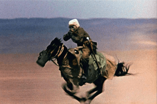 A Chinese People’s Liberation Army horseman riding towards a nuclear explosion whilst aiming a Kalashnikov during a Nuclear weapons test in Lop Nur, China (1964)