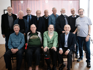a-large-group-of-older-men-standing-for-a-group-portrait-some-sitting-on-chairs-in-front-and-others-standing-behind-them.jpg...