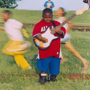 Christone “Kingfish” Ingram | 5 years old at a Gospel music festival, 2004