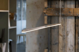 A rectangular lamp suspended using two pieces of wire at either end.