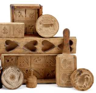 Group of chip-carved butter stamps and presses  19th century  Including three butter stamps, carved with an Eagle, cow, and daisy, a pate with two sheaves of wheat, a heart form mold, and two box molds.